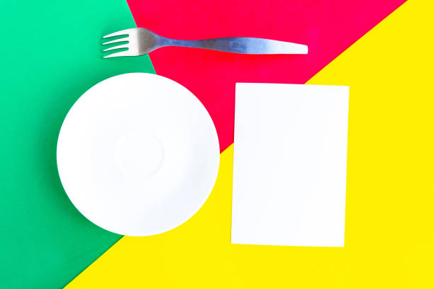 istock White mockup plate, fork and paper blank on color background. Copy space for the text. Minimal concept 1253068589