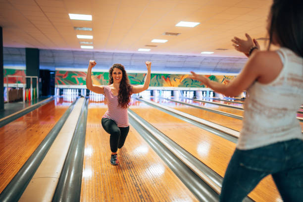 istock winning woman playing bowling 1253068592