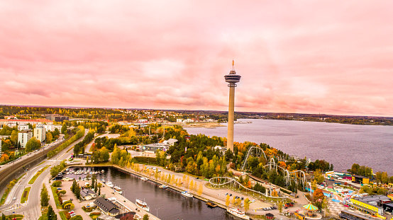This pic shows drone Aerial view of the Tampere city in autumn with colorful leaves. Maples trees and roofs can be seen in the pic.