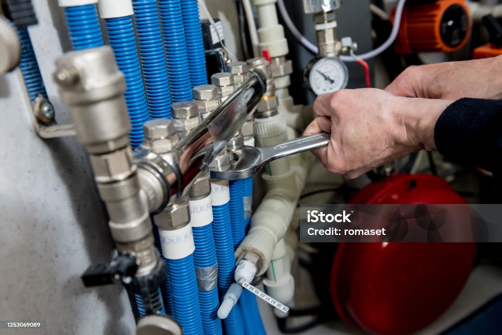 Heating Systems Engineering Heating Engineer Installing Modern Heating System In Boiler Room Stock ...