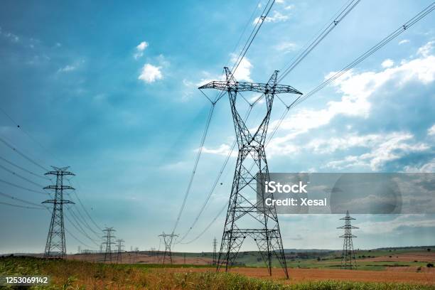 Electric Power Lines And Transmission Tower Stock Photo - Download Image Now - Electricity Pylon, Communication, In A Row