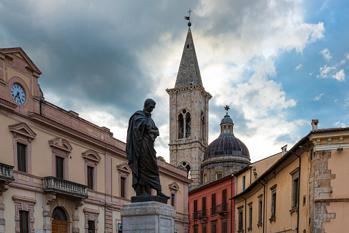 Sulmona, Italy - June, 08 2020 - An artistic city in province of L'Aquila, in the heart of Abruzzo region, Majella National Park, famous for the production of comfits. Here the historical center with a monumental square with old statue, bell tower and tourist