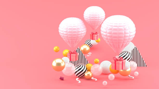 istock Pink balloon with gift box amid colorful balls on pink background.-3d render. 1253073289