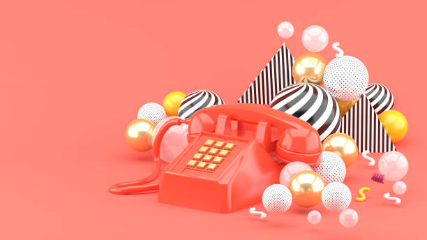 istock Pink phone among colorful balls on a pink background.-3d render.
