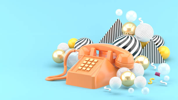 istock Orange phone among colorful balls on a blue background.-3d render.