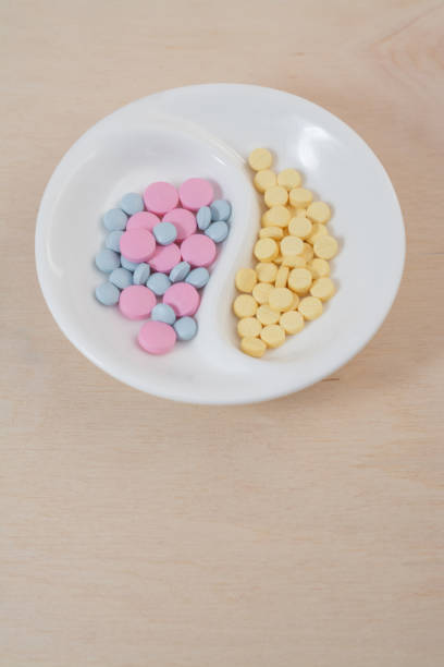 istock colored pills on a plate top view vertical photo 1253074975