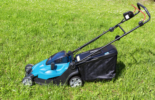 istock Lawn mower on green grass. Mower grass equipment, mowing gardener care work tool 1253077104