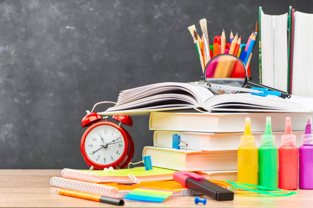 istock School supplies on a blackboard background 1253078936