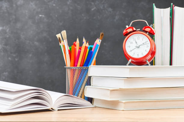 istock School supplies on a blackboard background 1253078945