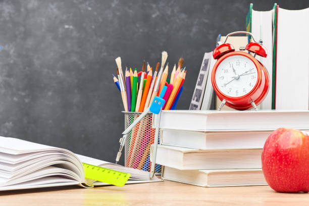 istock School supplies on a blackboard background 1253078952