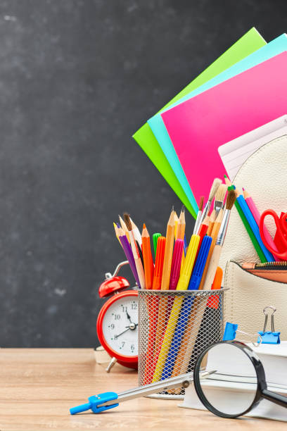 istock School supplies on a blackboard background 1253078976
