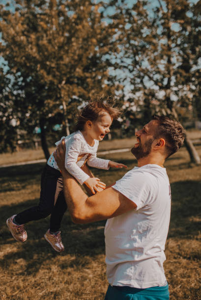 istock Father and daughter enjoy the park 1253079165