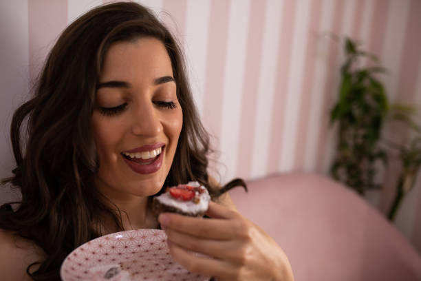 istock A beautiful woman happy about eating cake 1253080131
