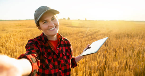istock Woman farmer with digital tablet makes selfie 1253080225