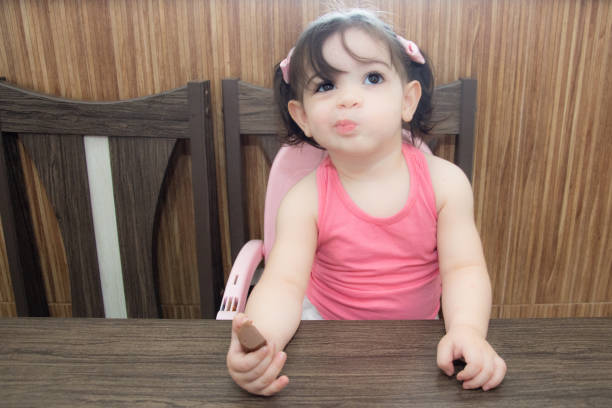 Sunny Chic: Baby Girl's Stylish Portrait in the Home Garden