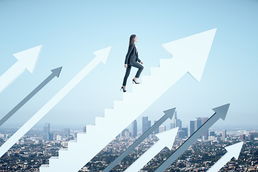 Businesswoman climbs the stairs in the form of white arrow on city background. Success and startup concept.