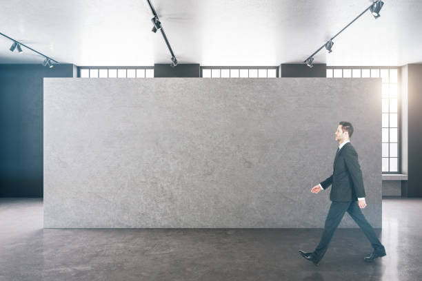 istock Businessman walking in clean gallery interior 1253082535