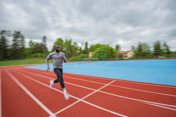 istock Young African American man running at tartan. 1253082576