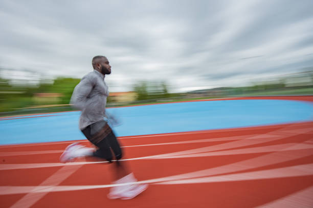 istock Young African American man running at tartan. 1253082628