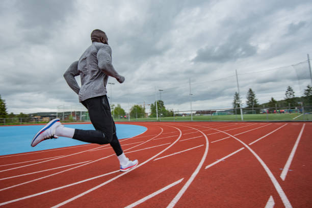 istock Young African American man running at tartan. 1253082697