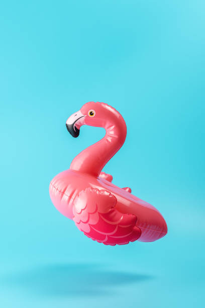 istock Inflatable pool toy flamingo on a blue background. Minimal summer concept. 1253083876