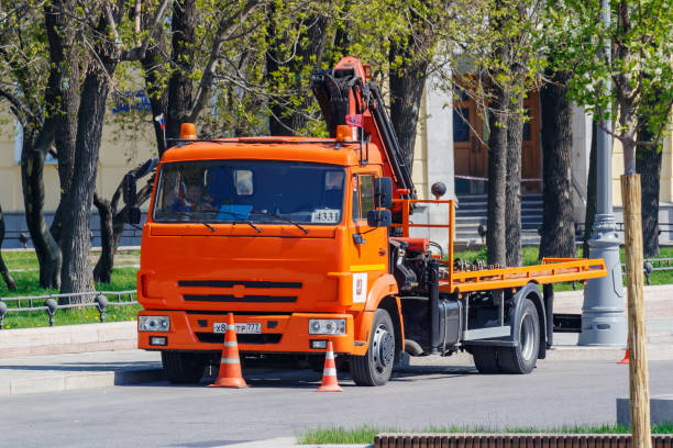 municipal orange tow truck parked on moscow street in sunny spring day - tow truck heavy truck delivering imagens e fotografias de stock