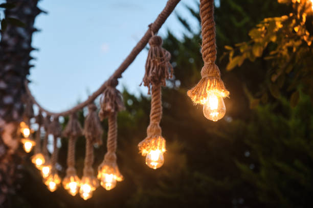 istock Decorative garden lighting design made with bulbs and thick rope 1253084015