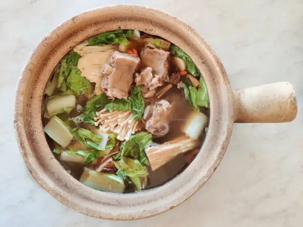 Photo of Bak kut teh serving in clay pot, a pork rib dish cooked in broth popularly served in Malaysia and Singapore