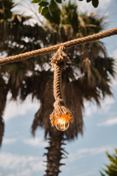 Decorative garden lighting design made with bulbs and thick rope