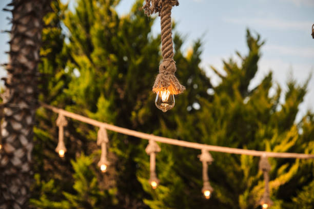 istock Decorative garden lighting design made with bulbs and thick rope 1253084668