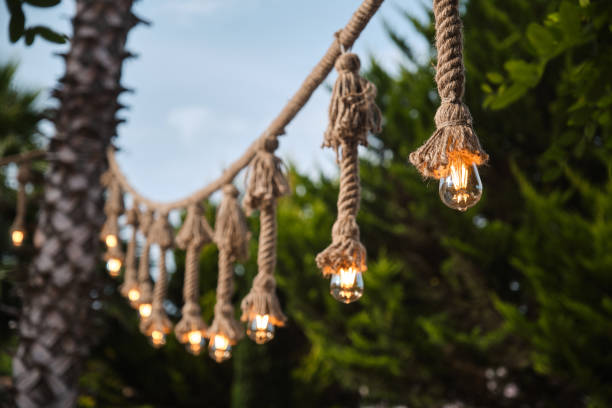 istock Decorative garden lighting design made with bulbs and thick rope 1253084752