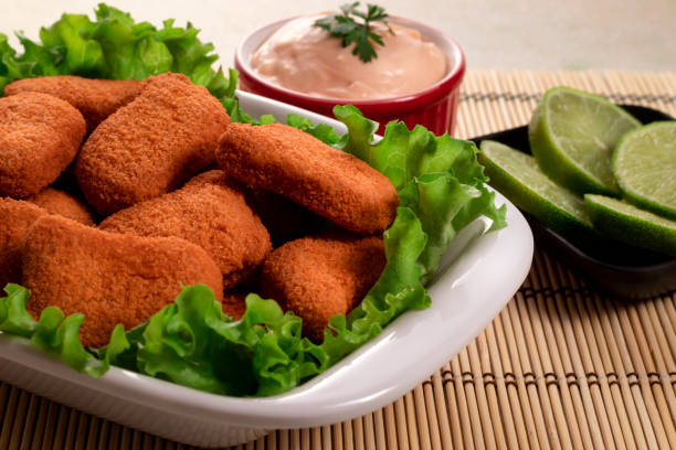 istock Breaded chicken with rose and lemon sauce 1253084999