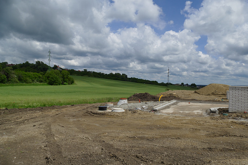 Family house construction site on green field