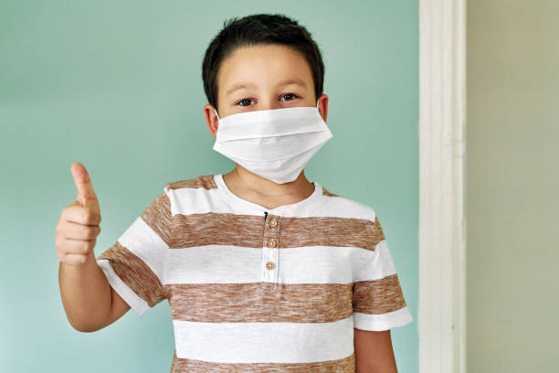 istock 6-7 years old cute child wearing surgical mask. 1253086077