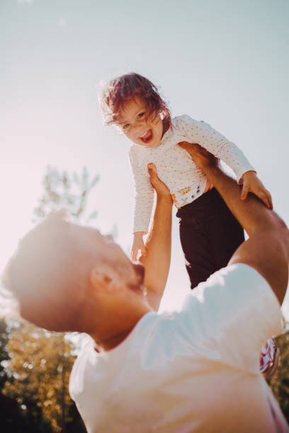 istock The father holds the daughter in park 1253086971