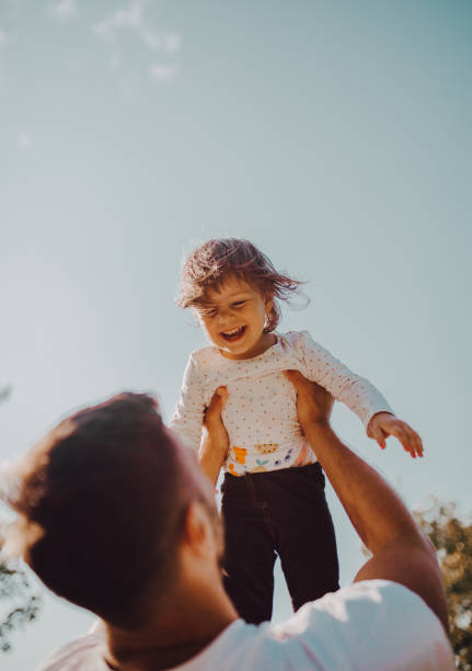 istock Father and daughter enjoy the park 1253086973