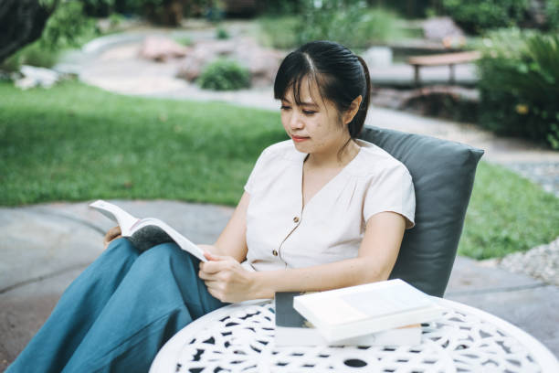 istock Woman relaxing and reading a book 1253087236