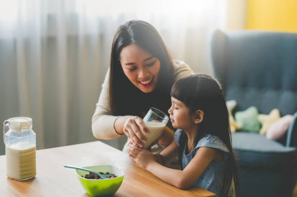 istock Happy Young Asian mother and her daughter preparing breakfast 1253087263