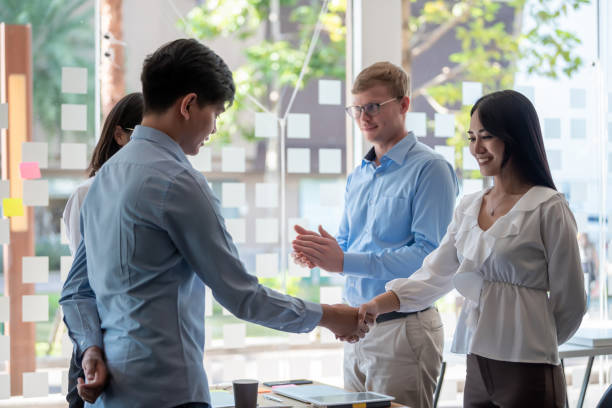 istock Young asian business people shaking hands during a meeting. 1253087346