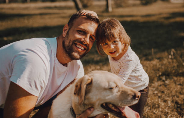 istock Young family with a dog 1253088106