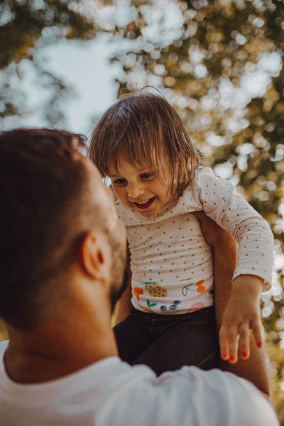 istock The father holds the daughter in park 1253088393