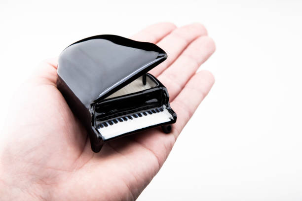 image of black piano hand white background