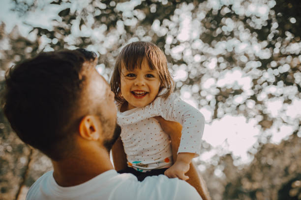 istock The father holds the daughter in park 1253088653