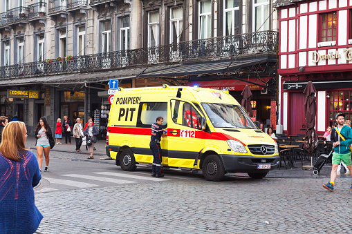 A white ambulance with red cross on the side and the words First Aid on the door