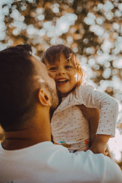 istock The father holds the daughter in park 1253089395