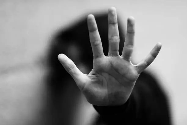 Photo of hand of the little girl who wants to protect herself with black