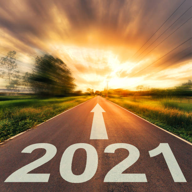 istock New Year Concept : Empty asphalt road sunset and New Year 2021. 1253090730