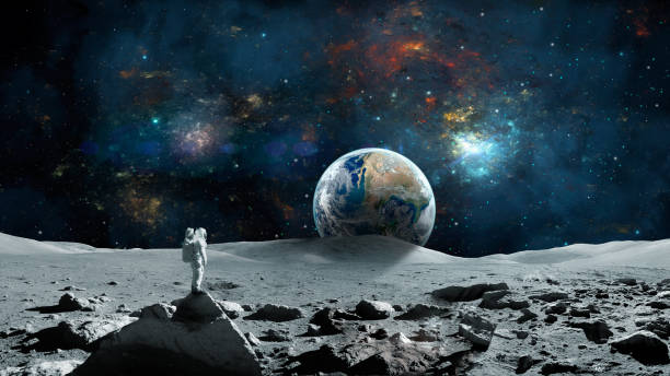 Space background. Astronaut standing on moon surface with earth planet and colorful nebula. stock photo