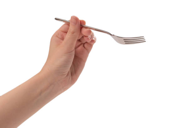 istock Fork in woman hand isolated on white. 1253091556