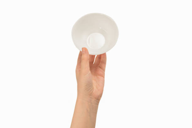 istock White bowl in woman hand isolated on white. 1253091564